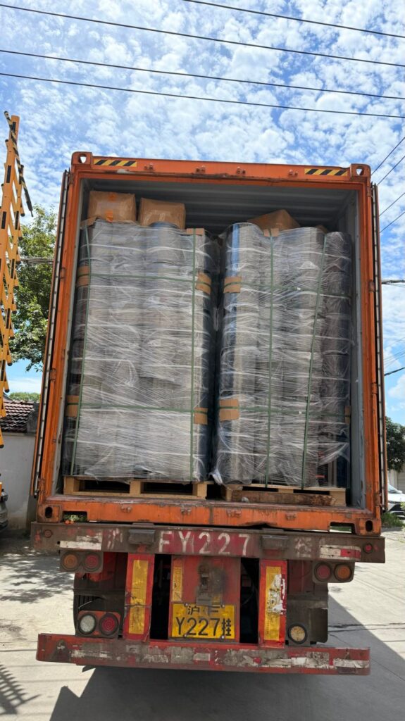 20L round steel pails loaded into a 40-foot HQ shipping container, wrapped in clear stretch film with green PET strapping, license plate 沪FY2227挂 (Shanghai registration)